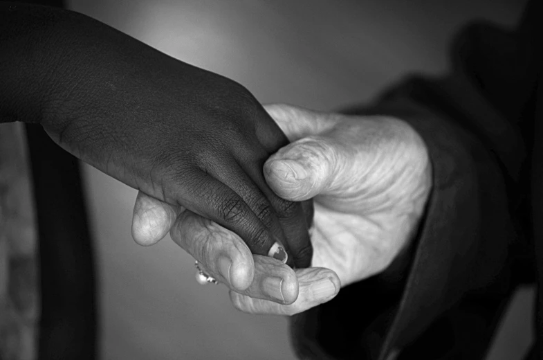 a black and white po of two people's hands