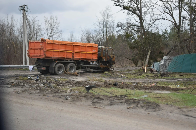 a big truck with a yellow top in a dirt road