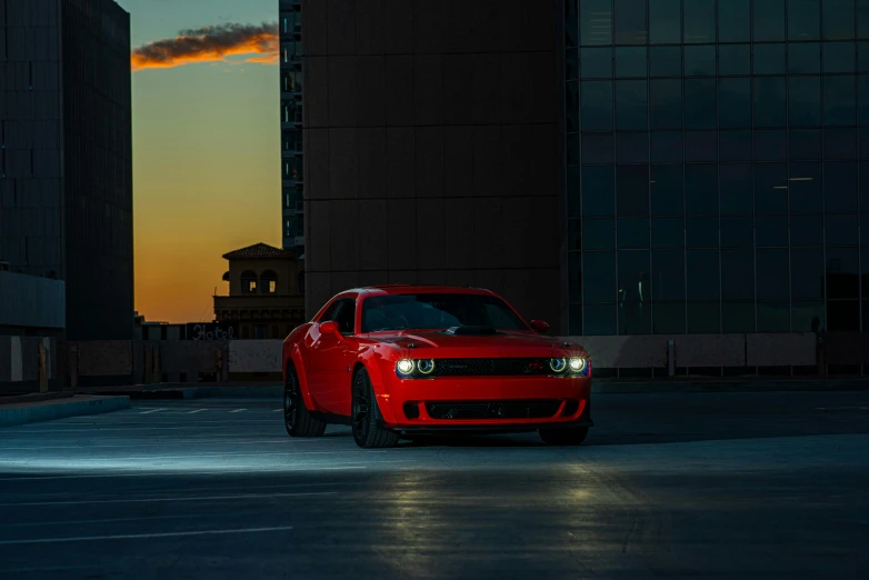 a red car is parked on an empty parking lot