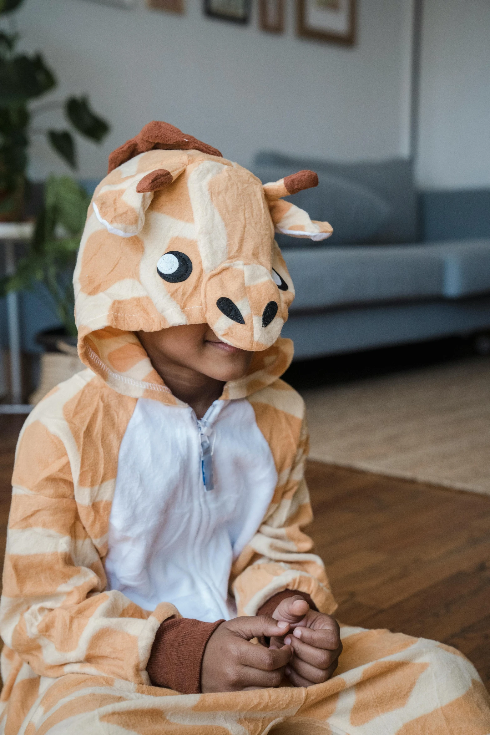 a little girl dressed in a giraffe costume