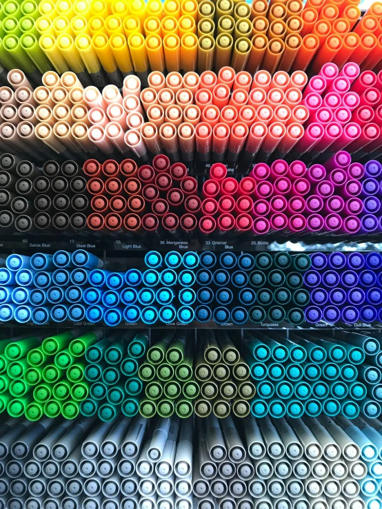 a close up of many different colored pencils