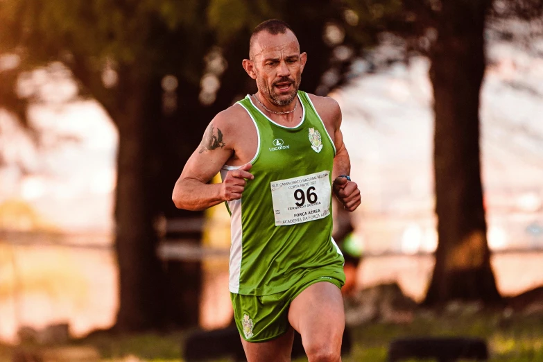 a man running down the road in a green shirt