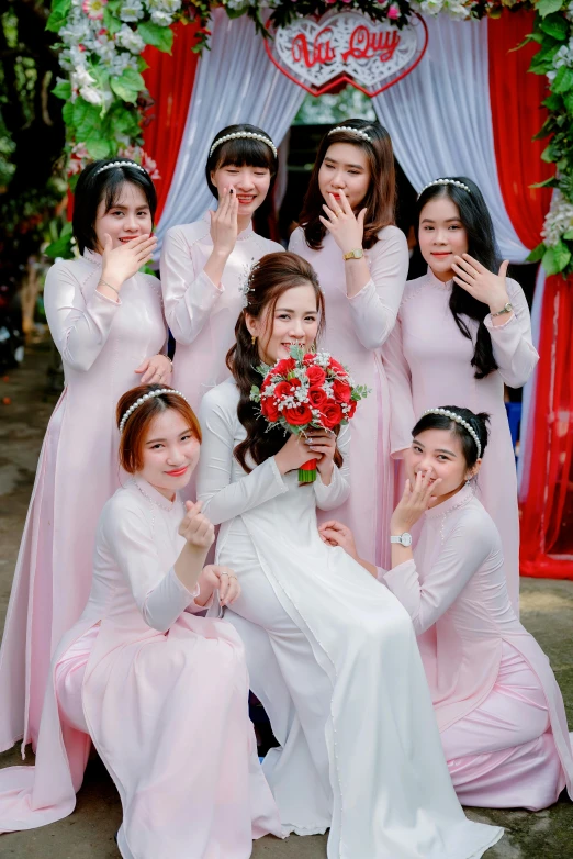 women dressed in dress with their bouquets and posing for a po