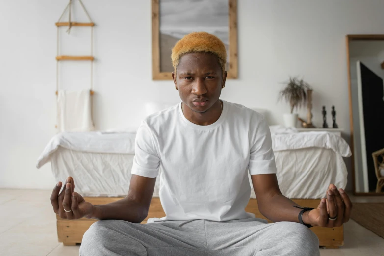 a man sitting in a chair with his hands clasped