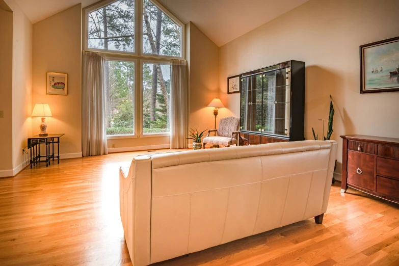 an ornate living room with hardwood floors and large windows