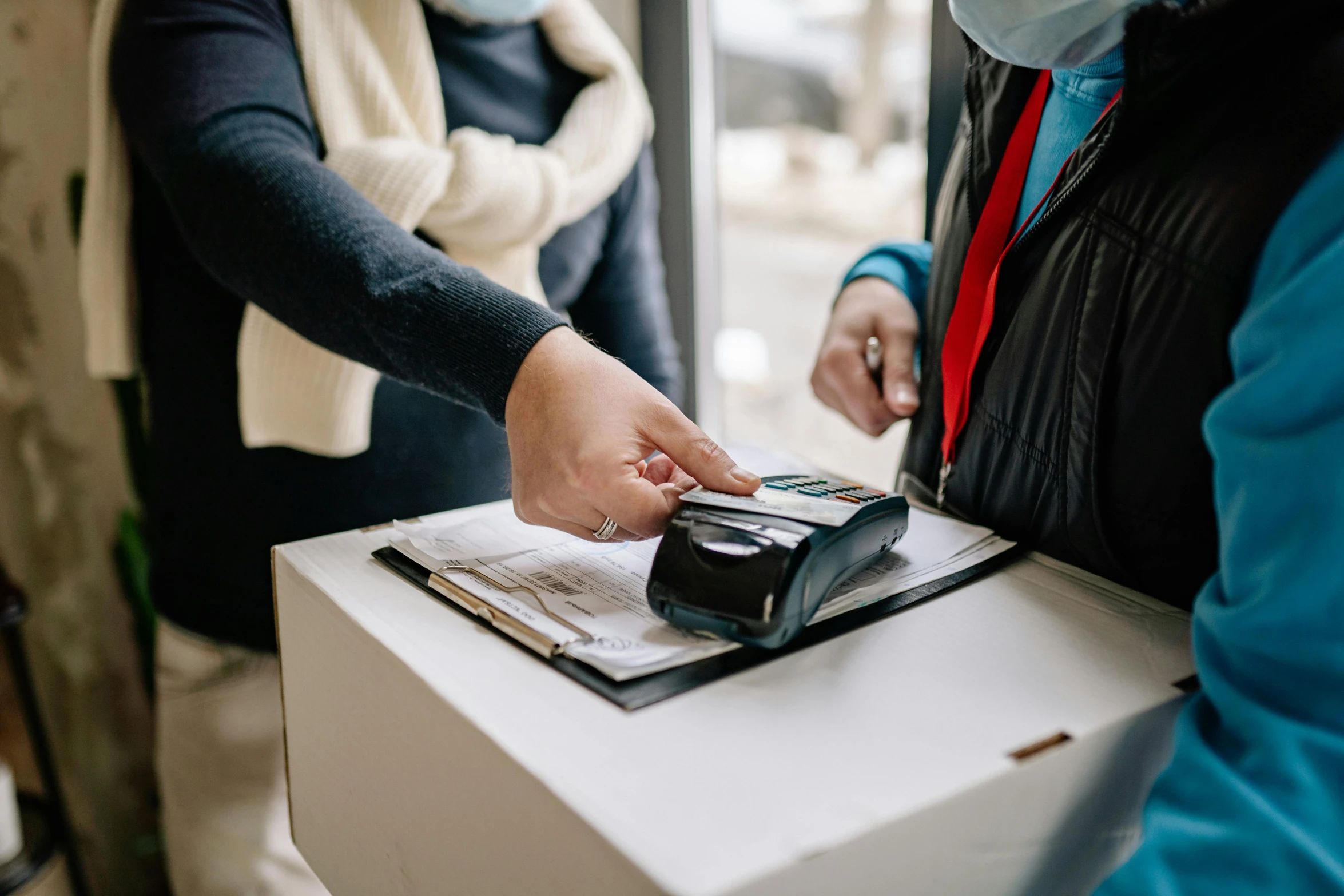 a person holds a phone and casts soing on a box