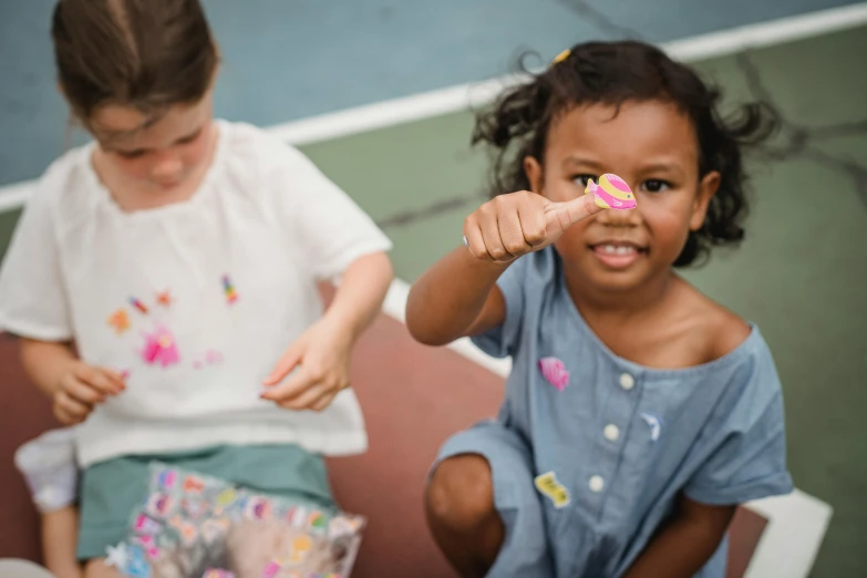 two small children with donuts in their hands