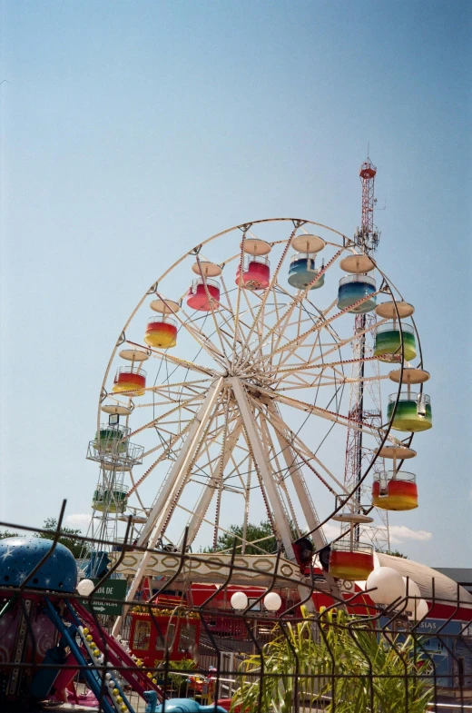 an amut park ride with the colorful carnival rides