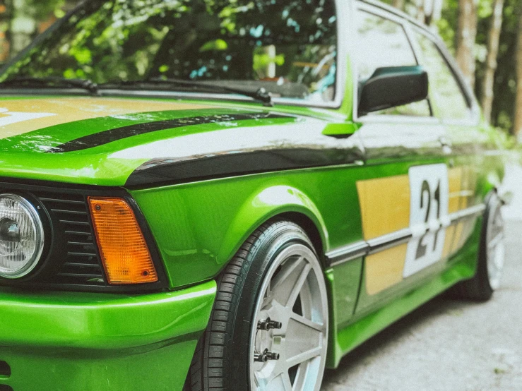 a close up of a green, black and white car