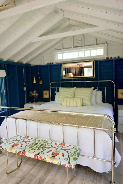 a bed sitting in a bedroom under a roof