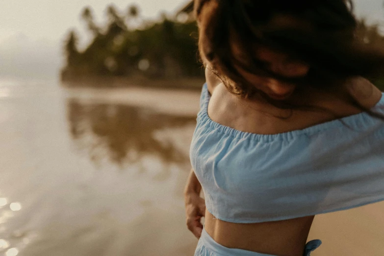 a woman wearing blue is looking at the water