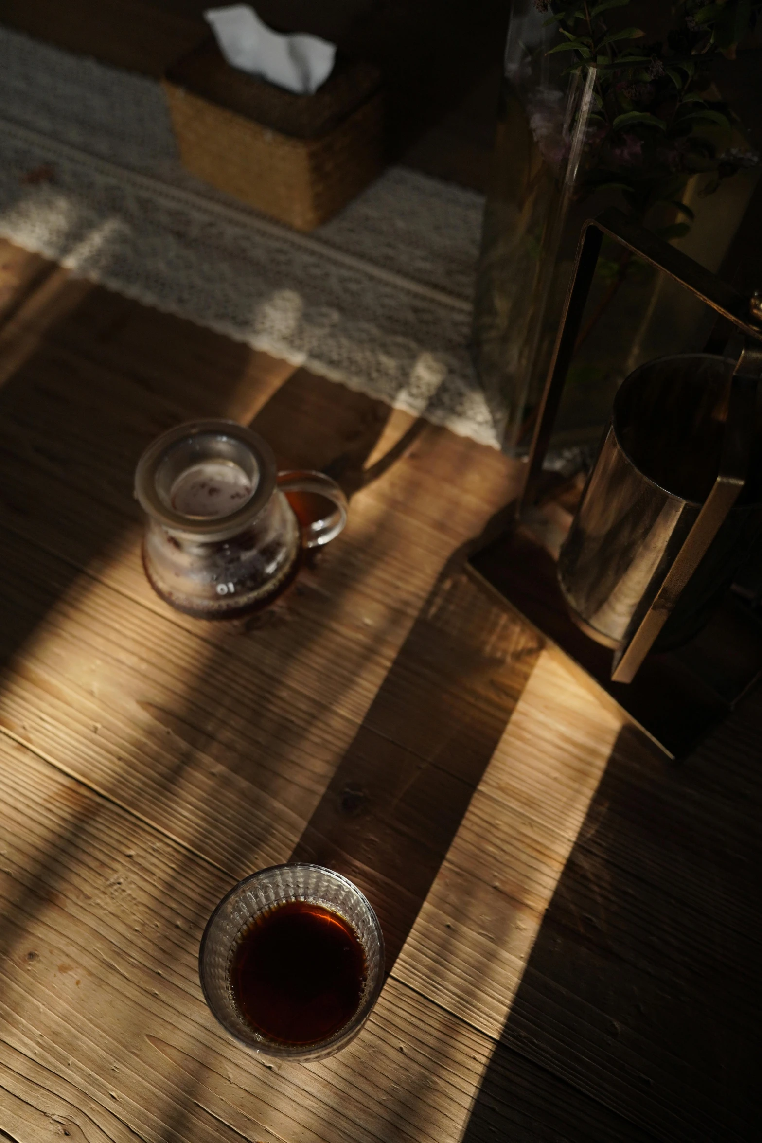 the glass cup is next to the empty cup on the table