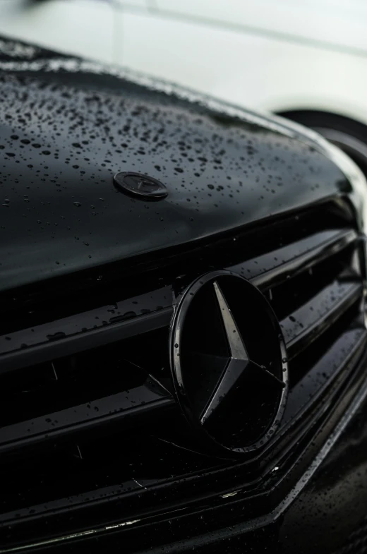 some black car hoods and water on the hood