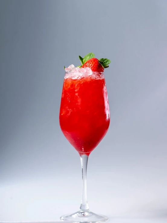 a strawberry cocktail on a plain table