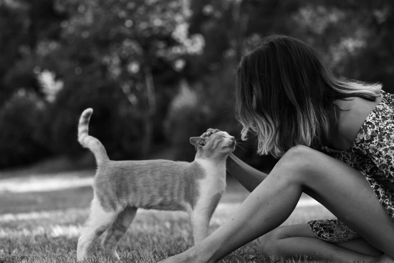 a woman that is petting a kitten