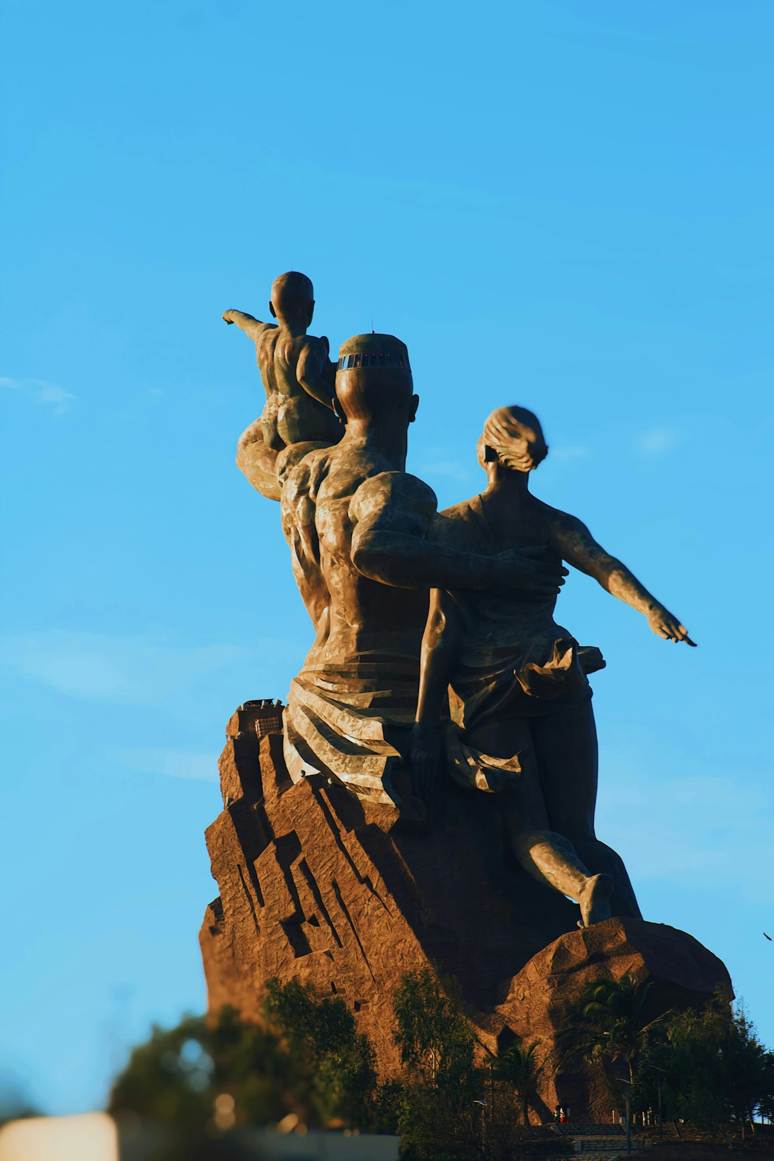 a statue of two men standing on top of a mountain