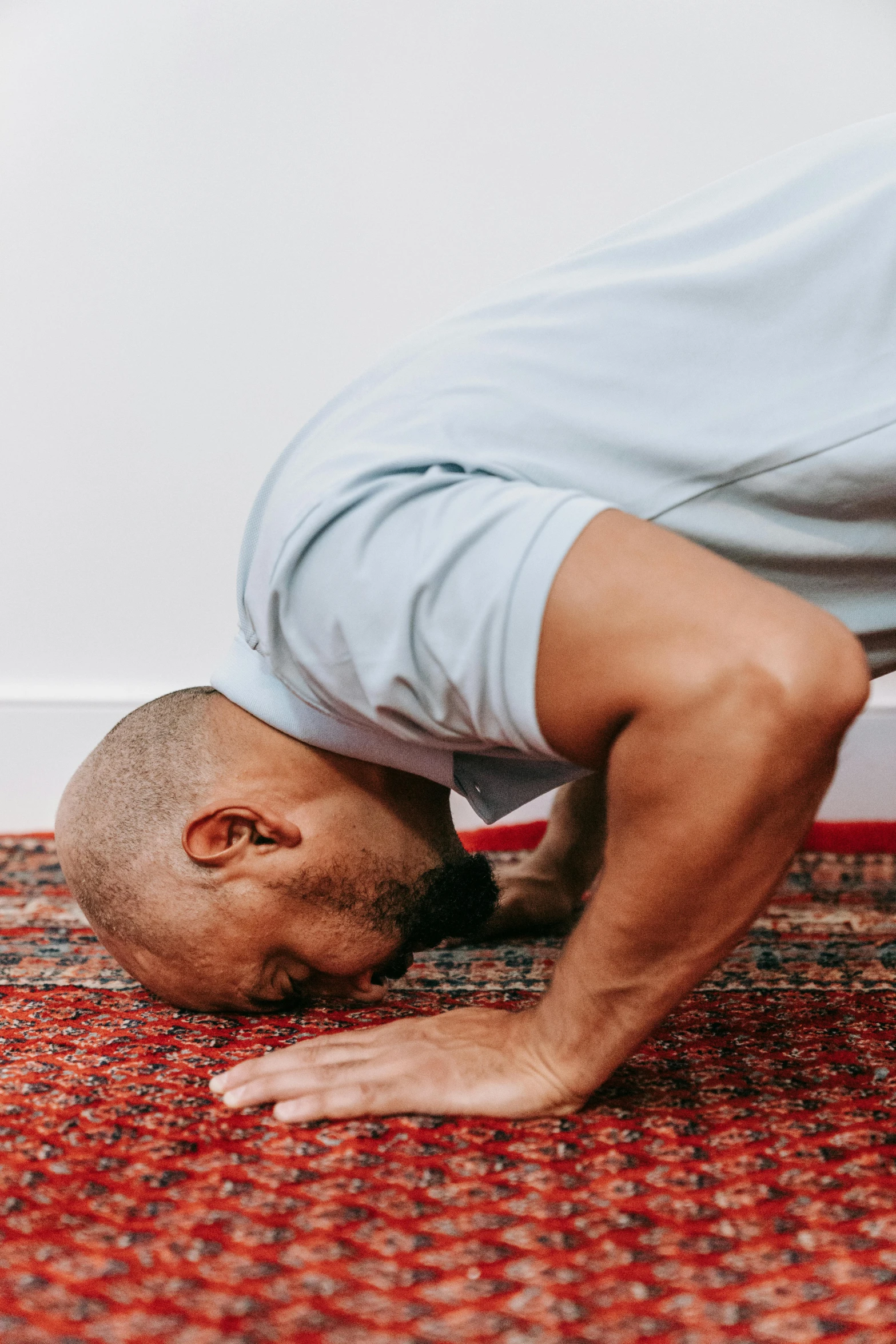 a man is practicing yoga on the rug