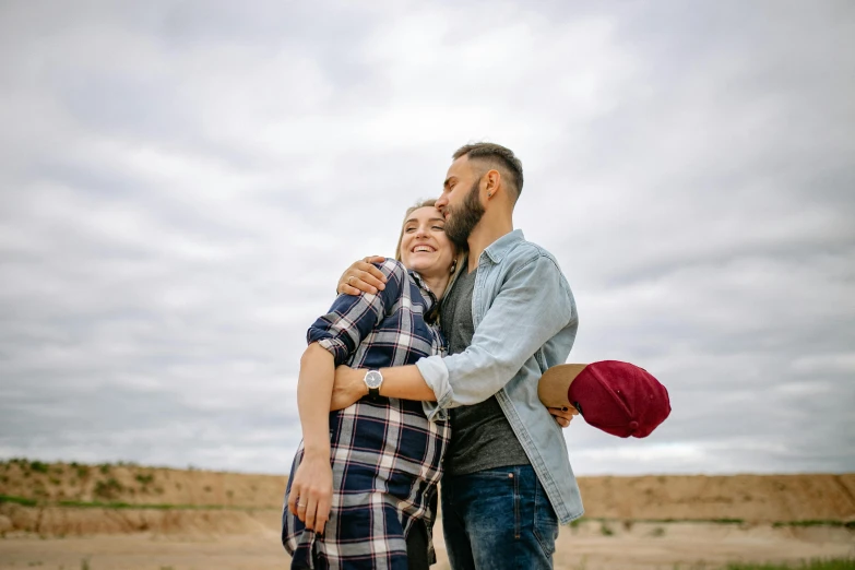 couple emcing in front of an empty field