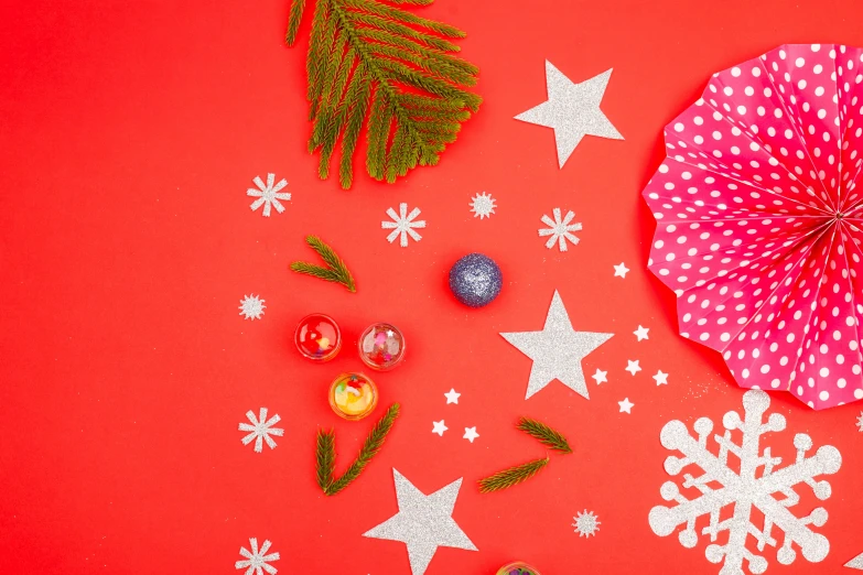 two paper parasols next to decorations and a red background