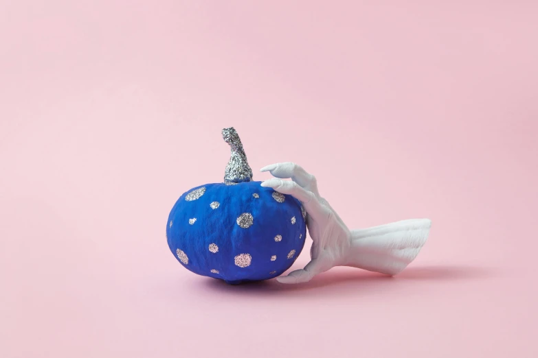 a blue apple decorated with silver foil and hearts