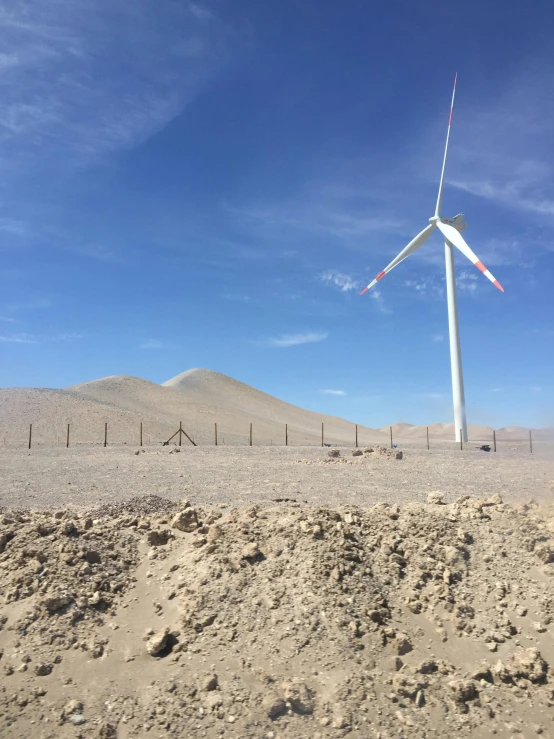 wind turbines at the desert site near fenced area