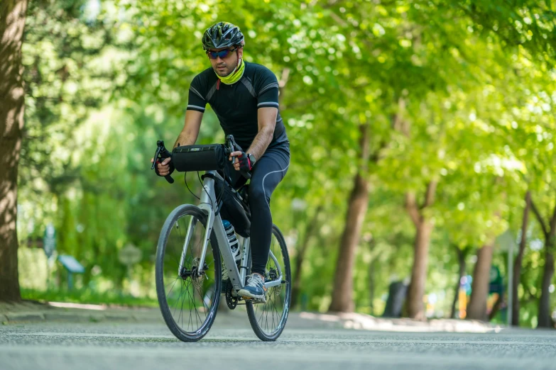 a man is riding his bike around the park