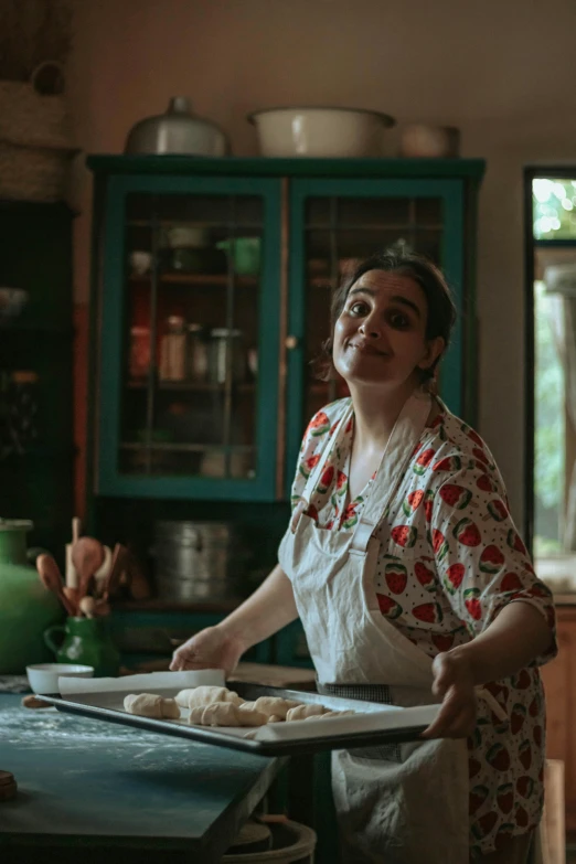 a woman in an apron is making food