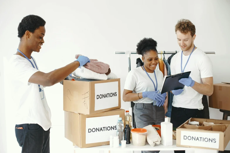 a couple of people working on a cardboard box