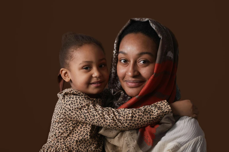 the woman and the child are both dressed up together