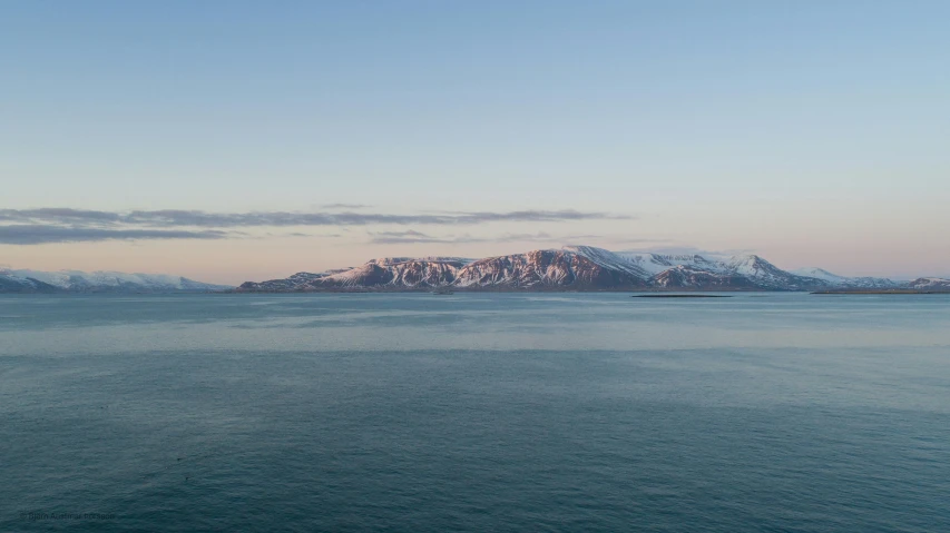 mountains and snow in the distance in an island