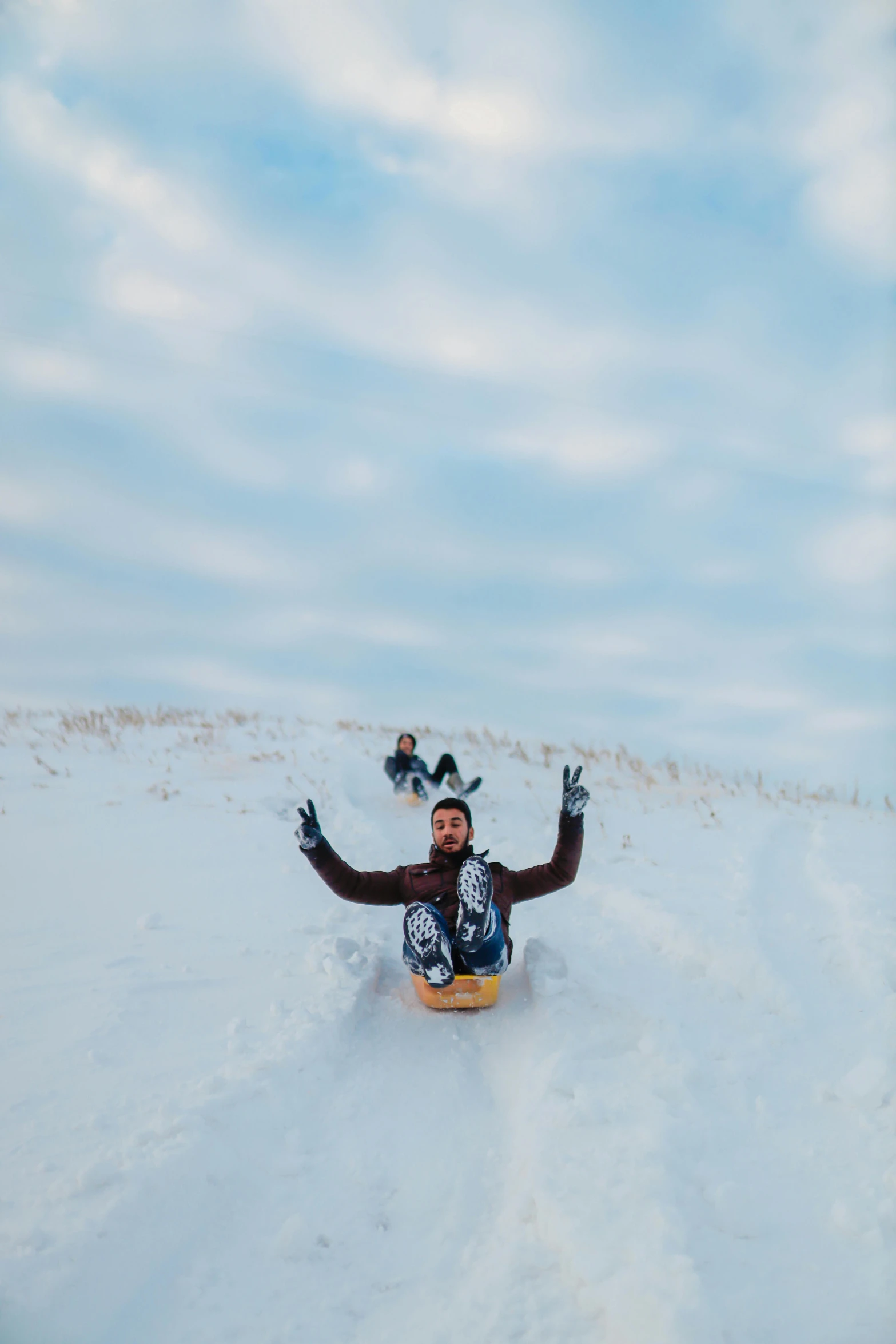 a man laying on the snow with his hands up