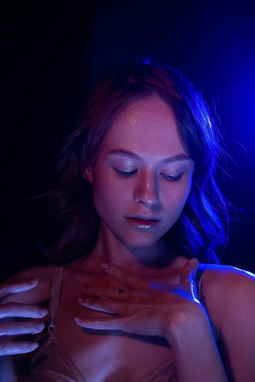 a woman with face paint standing in the dark