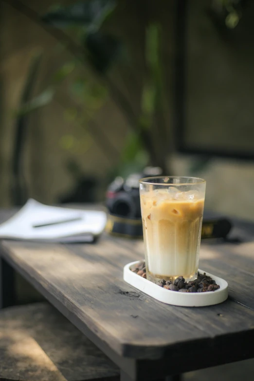 a glass of beverage on a table in a restaurant