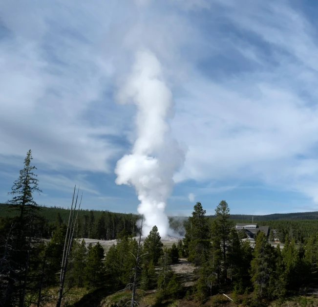 an enormous plume of smoke rises from a small pond