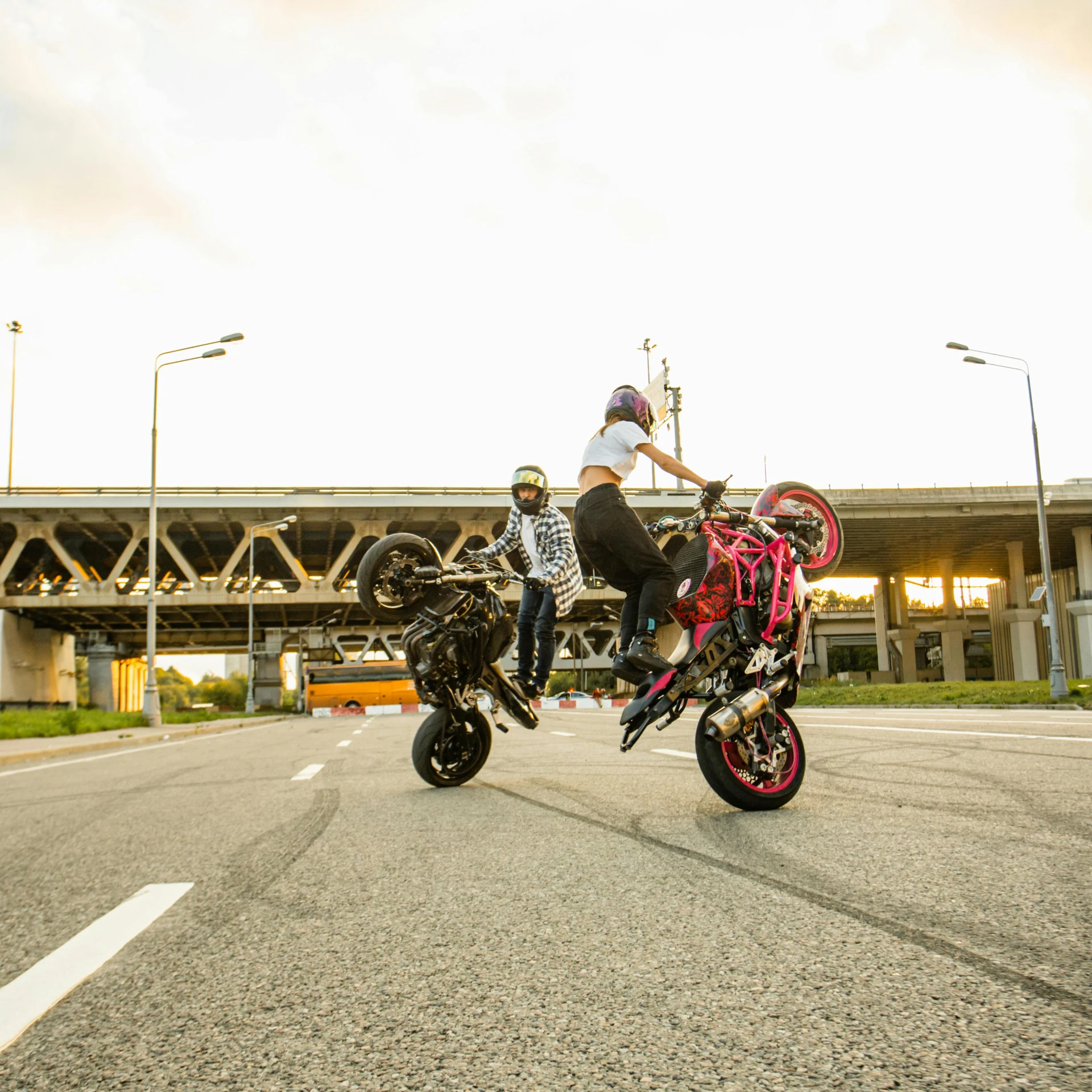 a man riding a motorcycle in front of a woman riding a bike