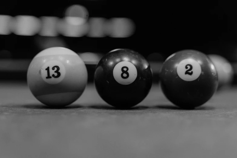 billiard balls lined up in a row on the pool table