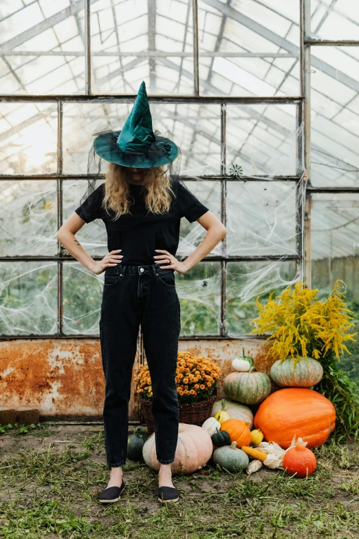 woman standing in front of a variety of pumpkins