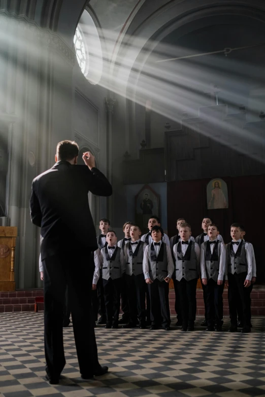 several people in front of an audience and light beams