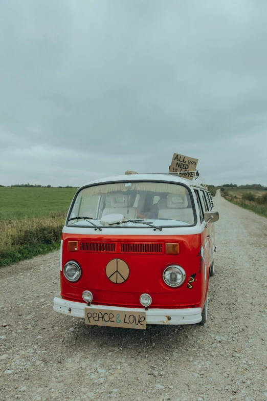 the old red van has a peace sign on it