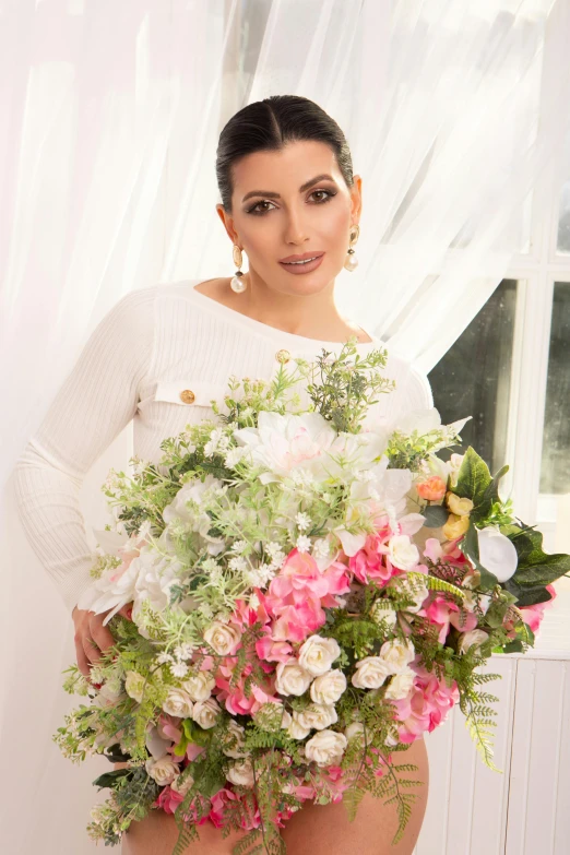 a person that is holding some flowers in her hand