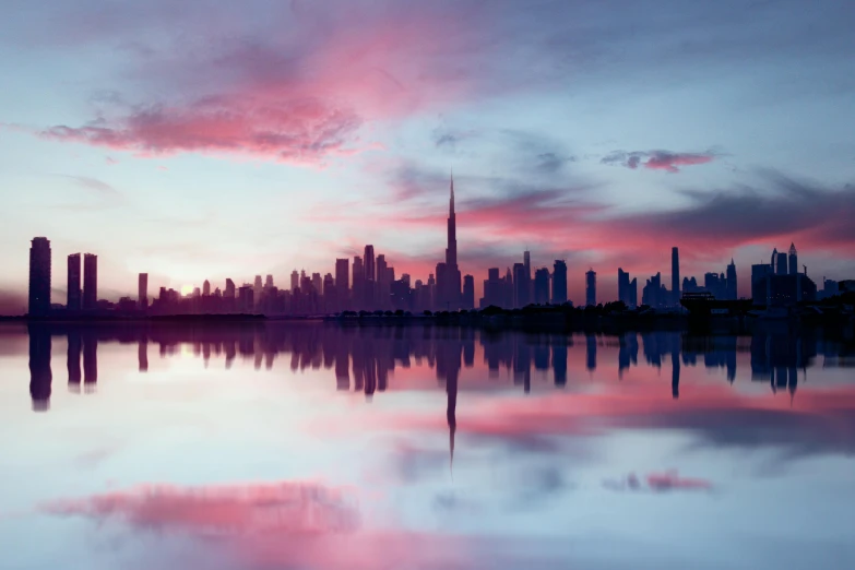 a city on the water during a beautiful sunset