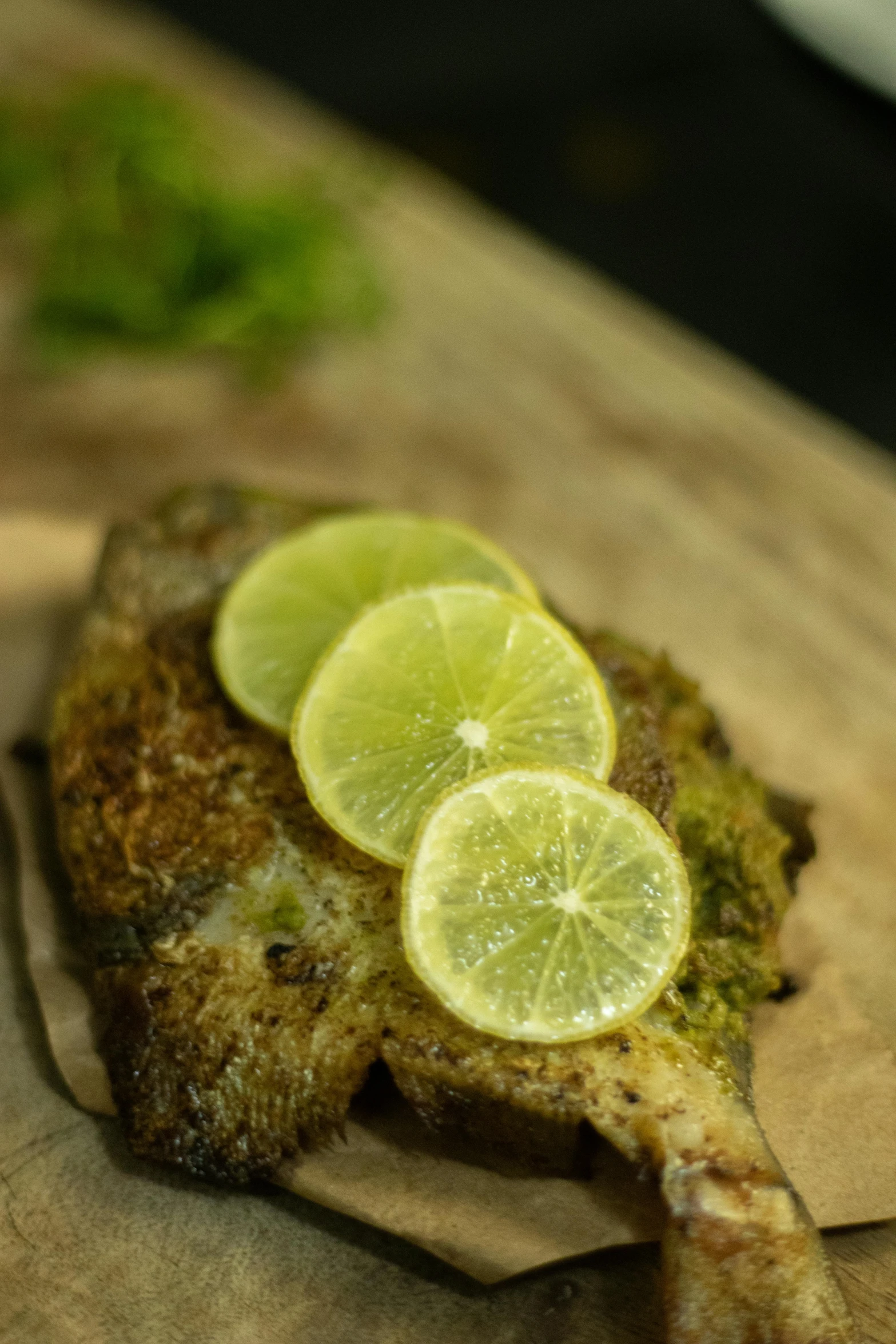 a piece of food with limes on top of it