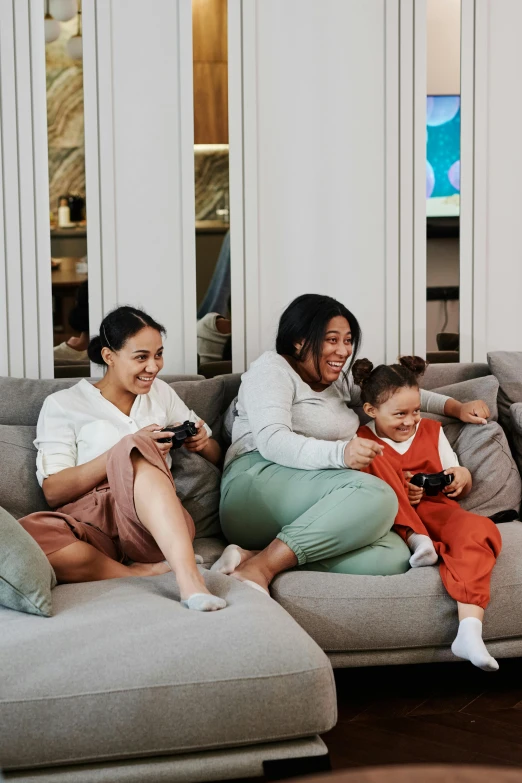 a woman and two young children sitting on a couch