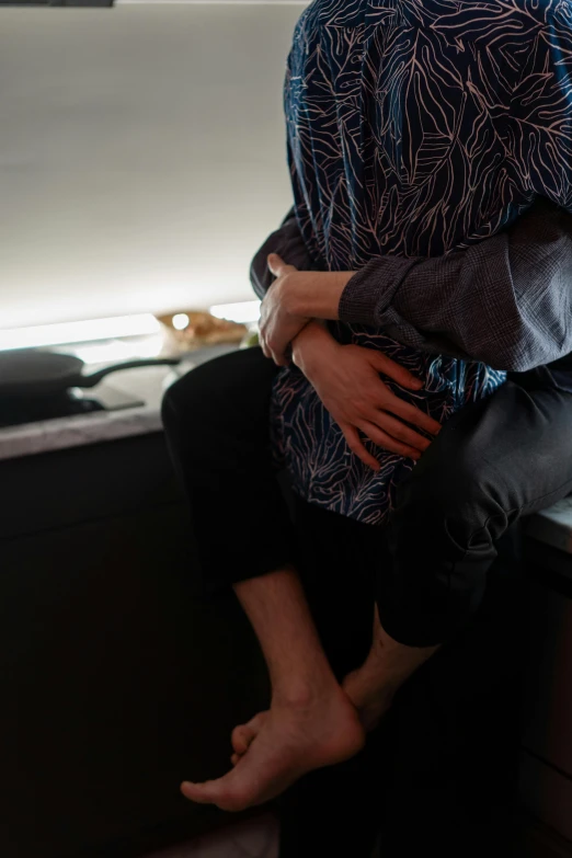 a person in a blue and white shirt is holding another person