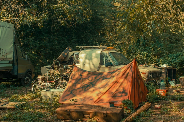 a tent next to a bike near a wooded area