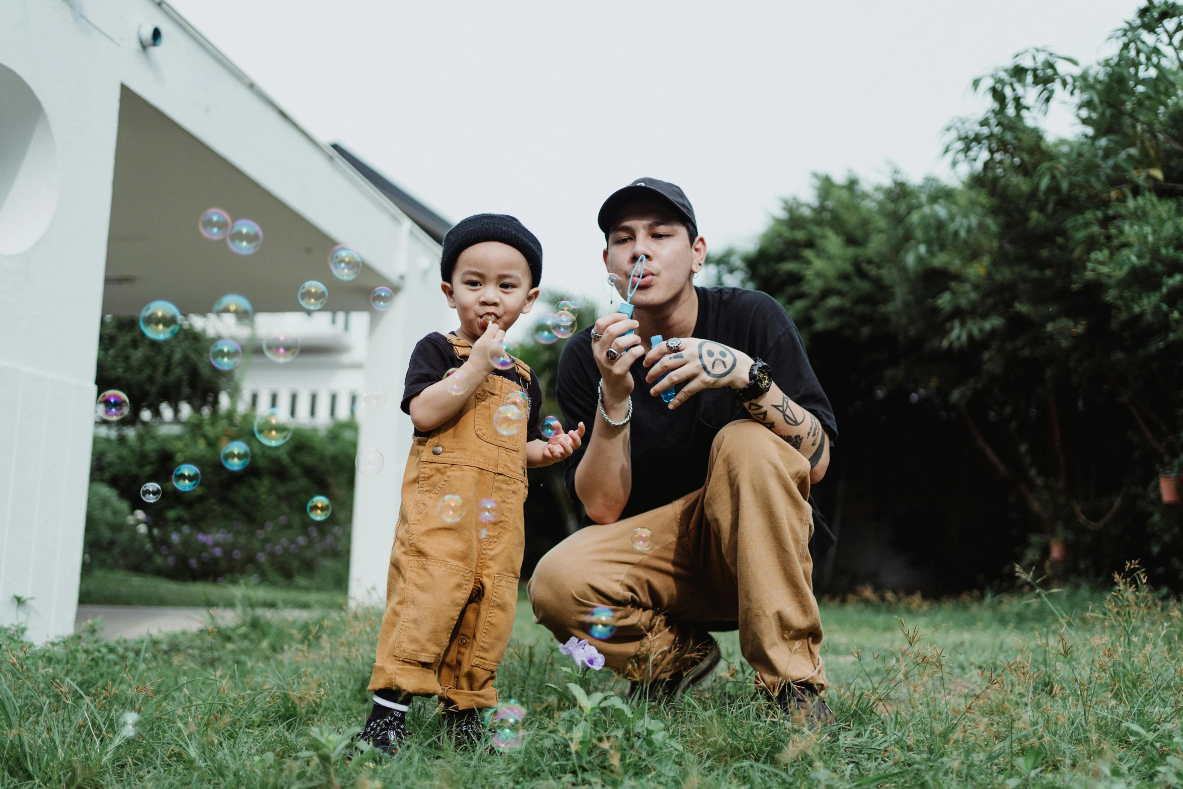 two young people who are blowing bubbles