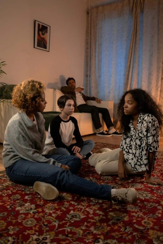 five young adults in a living room with rug