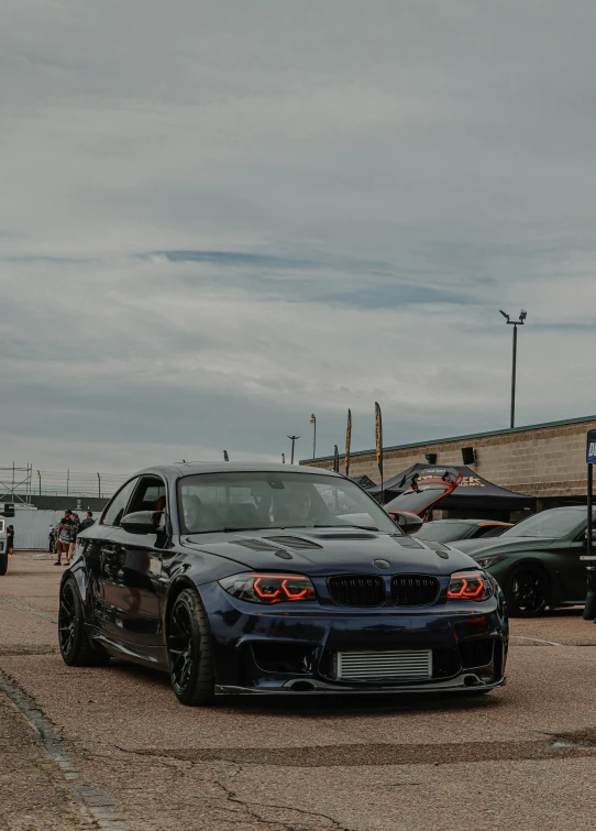 a blue car in front of a brown car parked