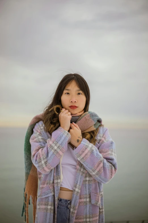 a woman wearing a plaid coat and scarf