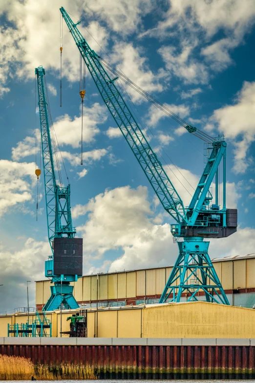 a blue crane is on a large brick wall